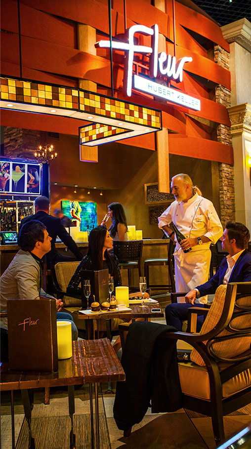 Chef Hubert Keller greeting dining guests at Fleur